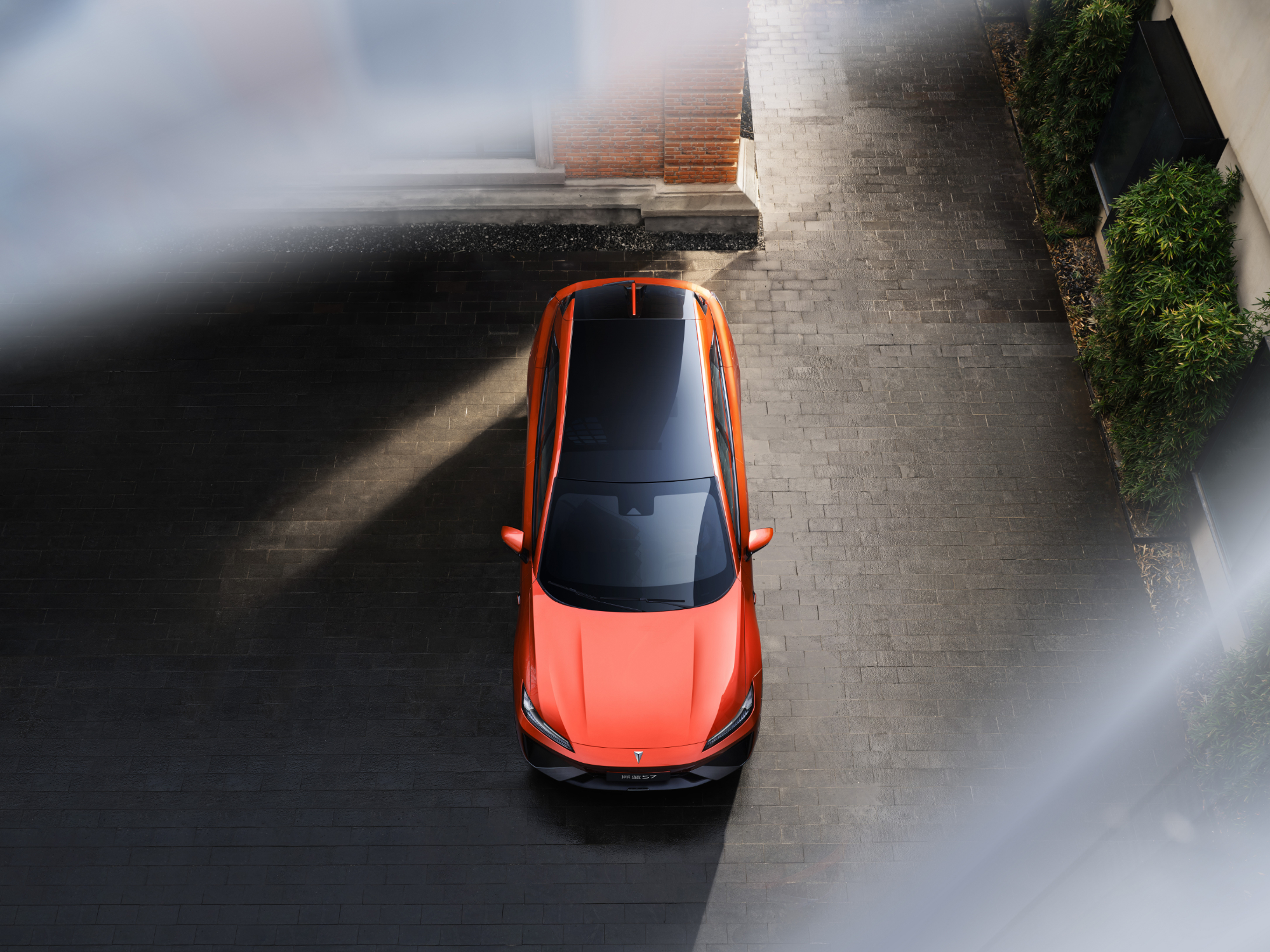 bold orange car on driveway