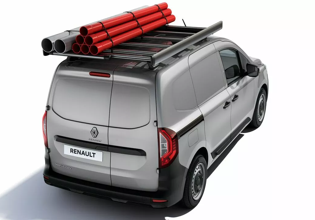 Rear three-quarter view of a silver Renault Kangoo van fitted with a roof rack carrying a bundle of red and silver industrial pipes.
