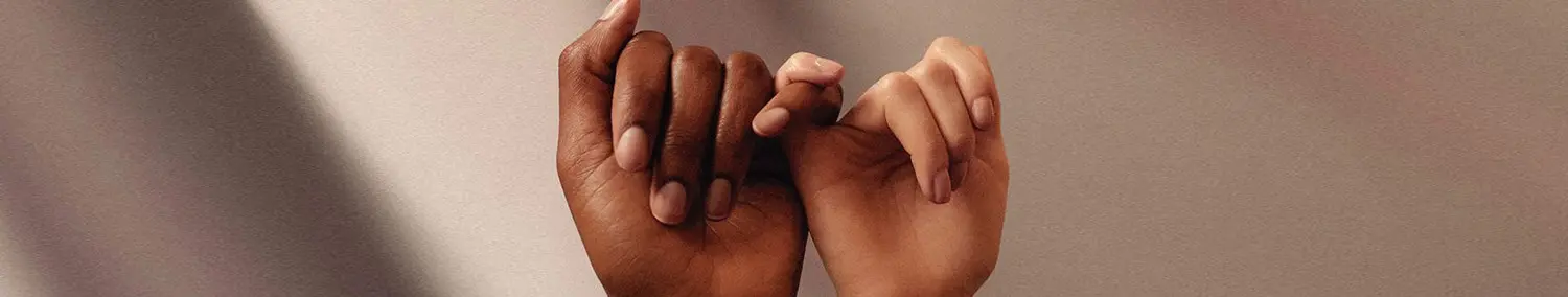 Two people holding pinkies