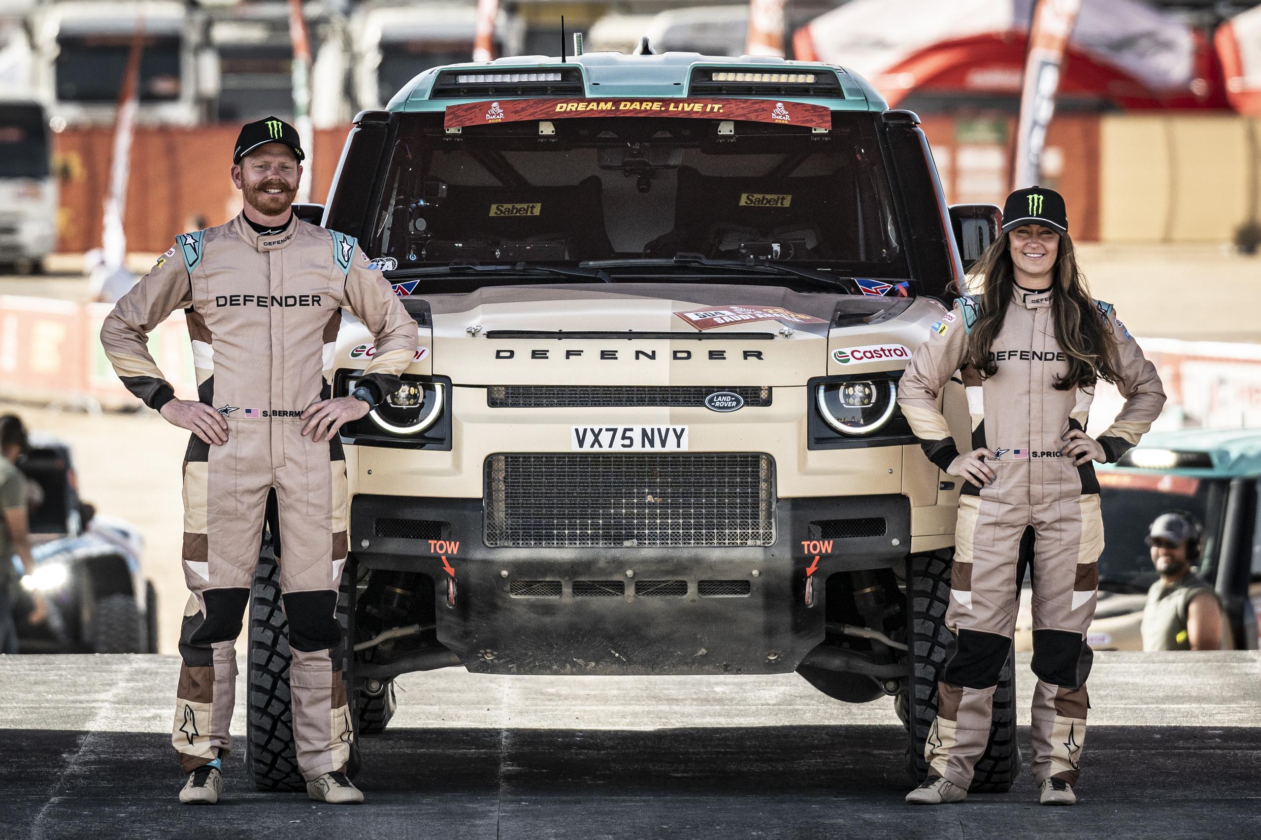 drivers infront of a Land Rover Defender for the rally 