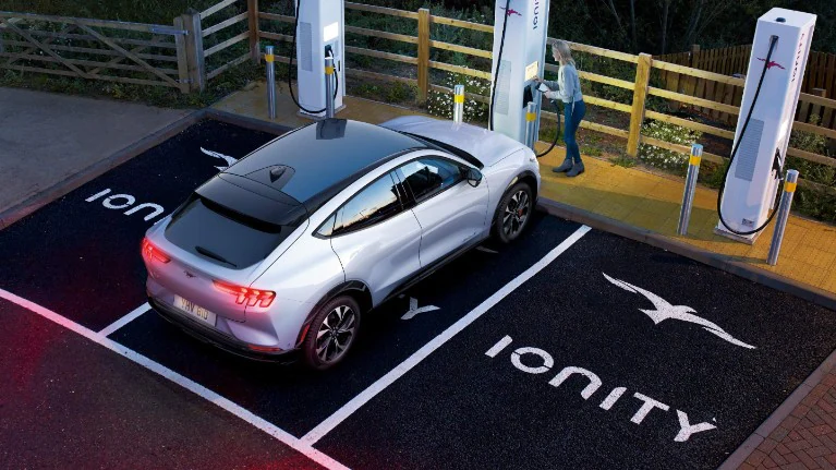 Ionity charging station with a white car parked in one of the slots.