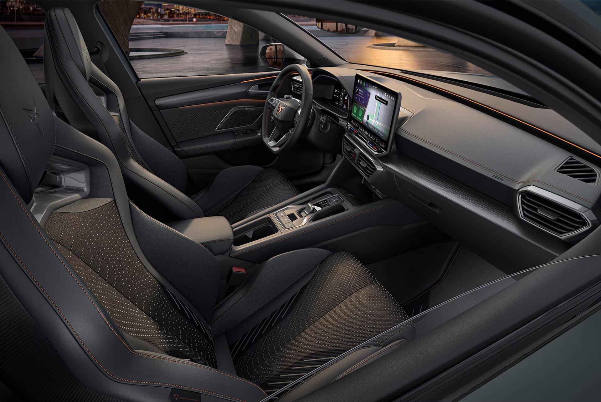 CUPRA Leon interior showcasing the front seats, steering wheel and central touchscreen.