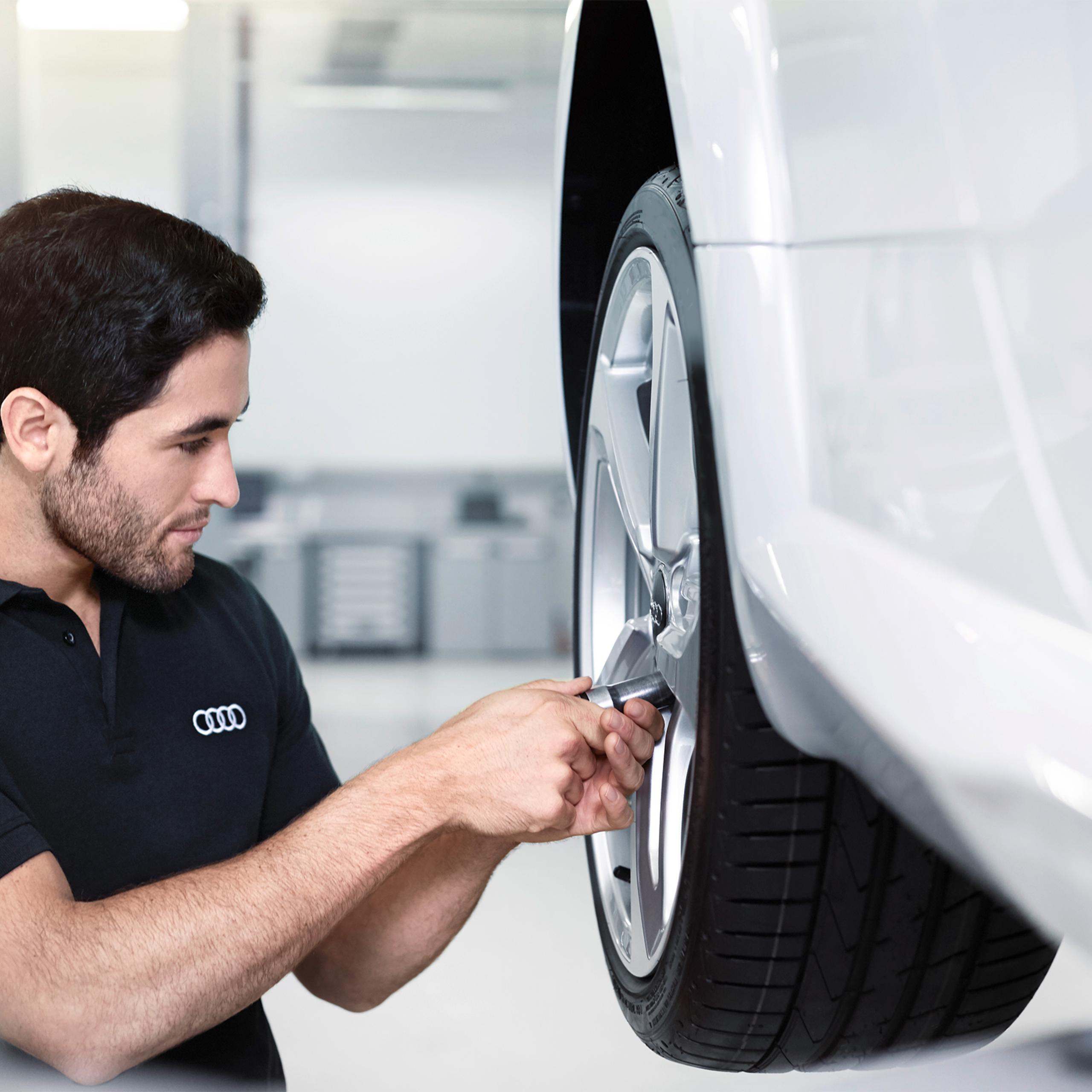 Mechanic Working on vehicles wheel