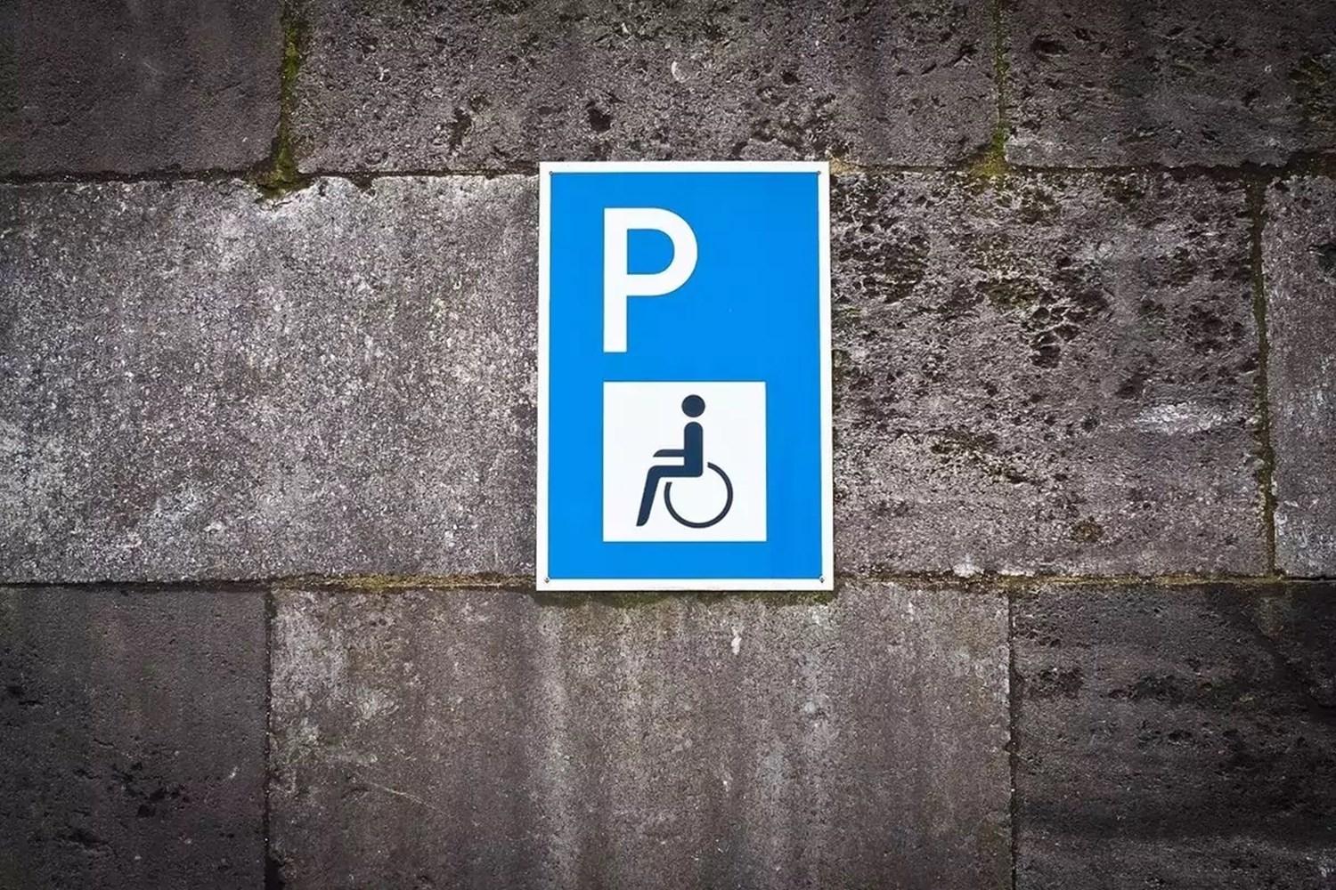 Blue disable parking sign on wall