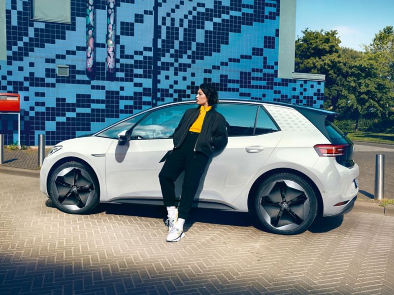 Person Leaning on White Volkswagen