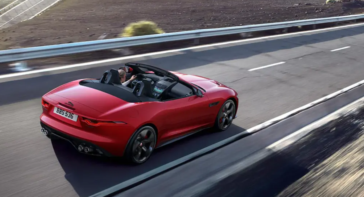Red F-Type convertible coupe driving