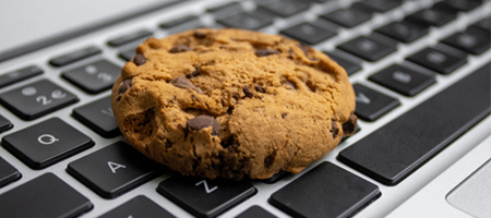 A chocolate-chip cookie on a computer keyboard