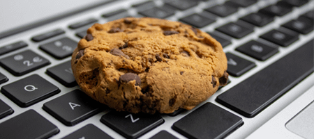 A chocolate-chip cookie on a computer keyboard