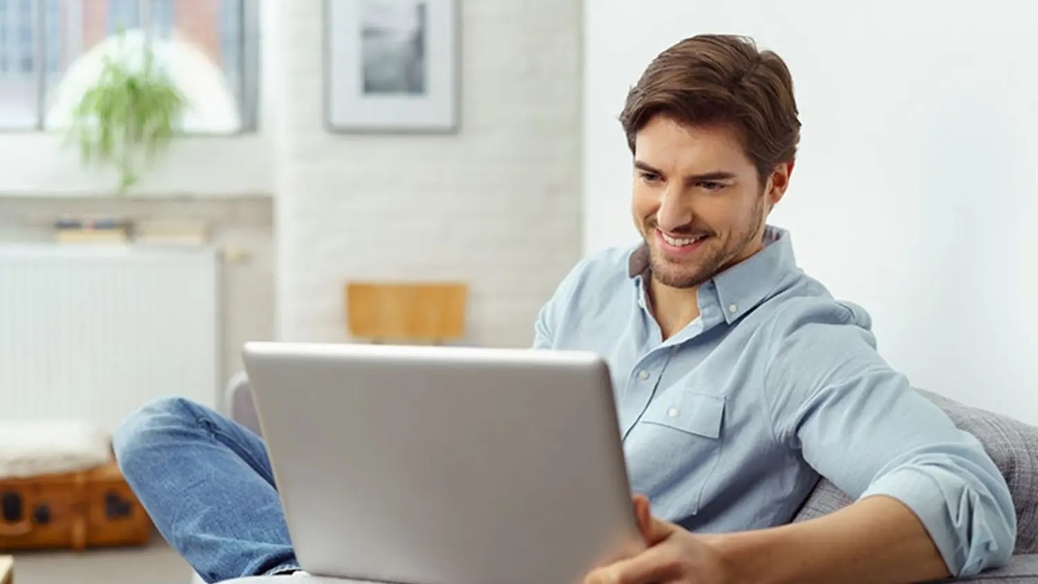 A man looking at a laptop