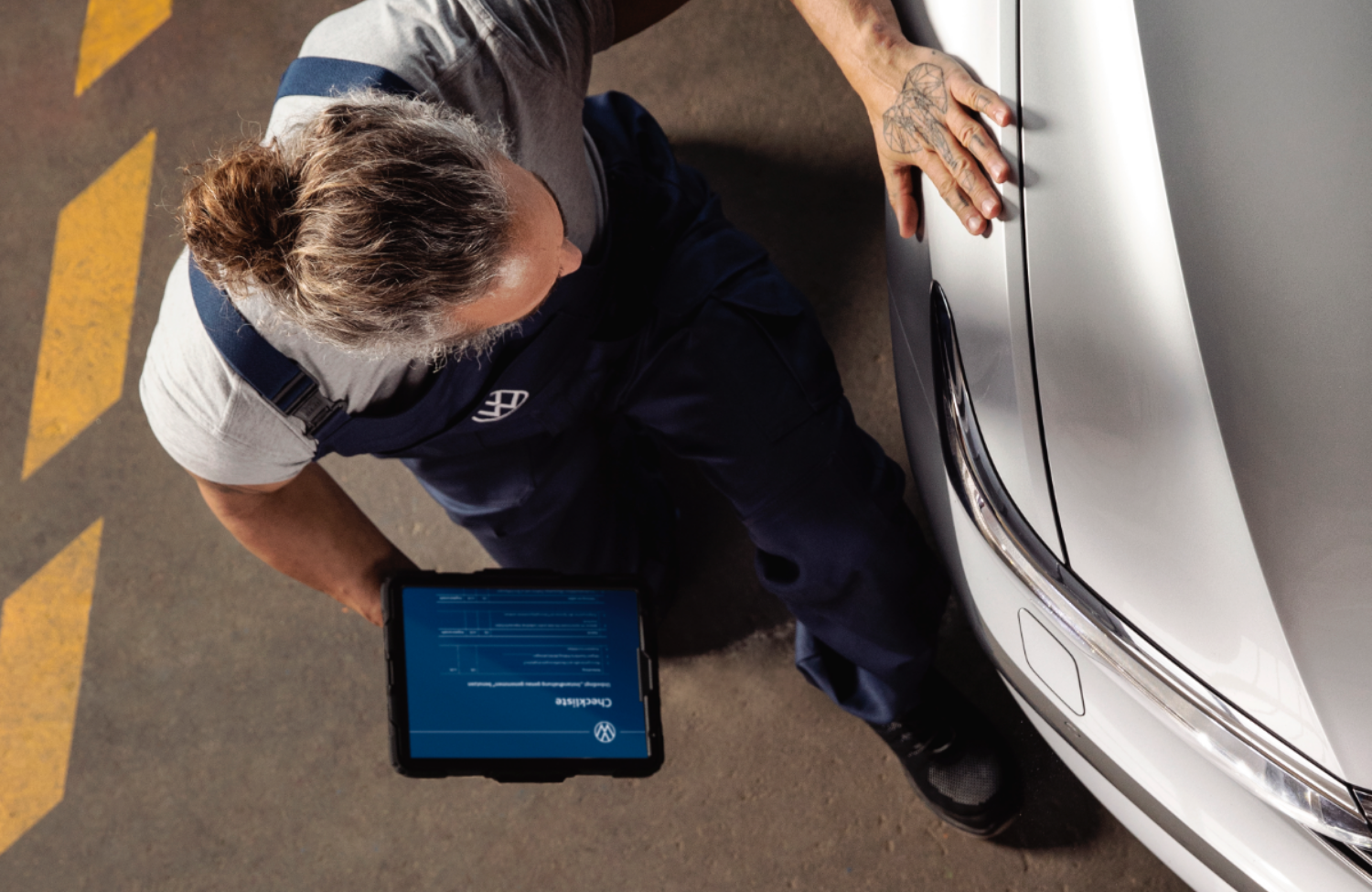 Volkswagen Mechanic Inspecting Vehicle
