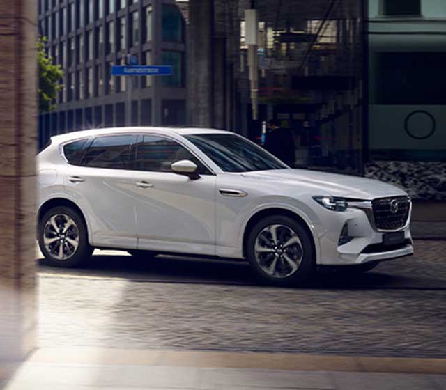 white mazda cx-60 diesel on urban road