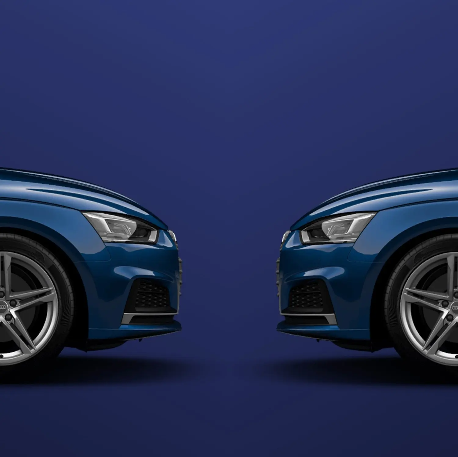 Two Audi Vehicles Facing Eachother