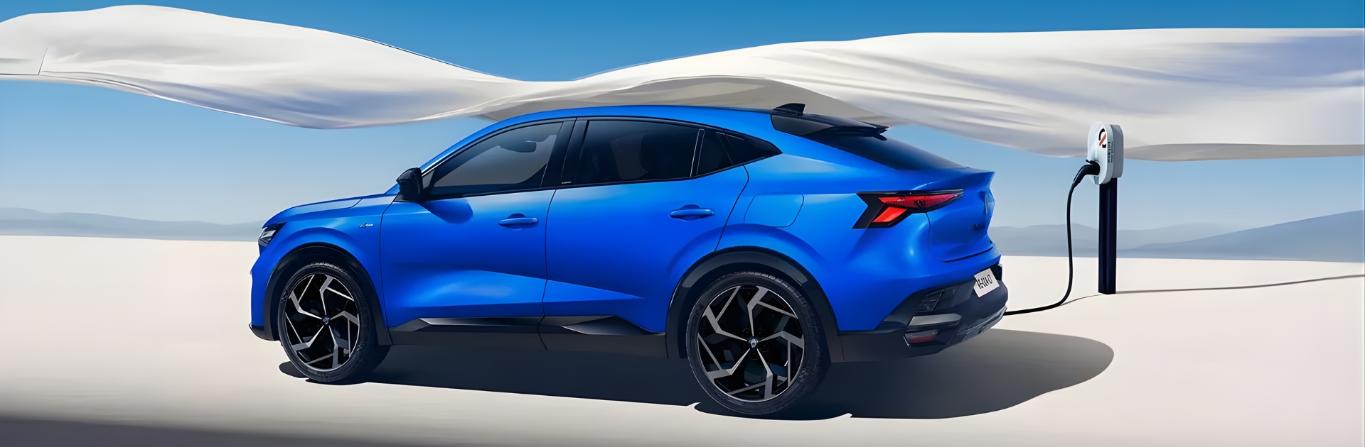 Side rear view of Renault Rafale E-Tech Electric in blue, charging in a desert setting, highlighting coupe-SUV design and sleek rear styling.