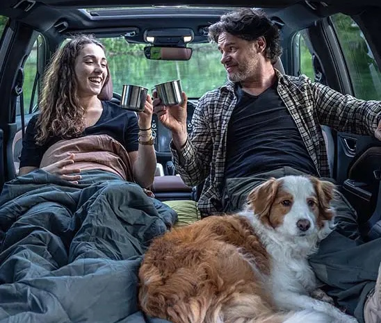 man, woman and dog in a All-New Subaru Forester