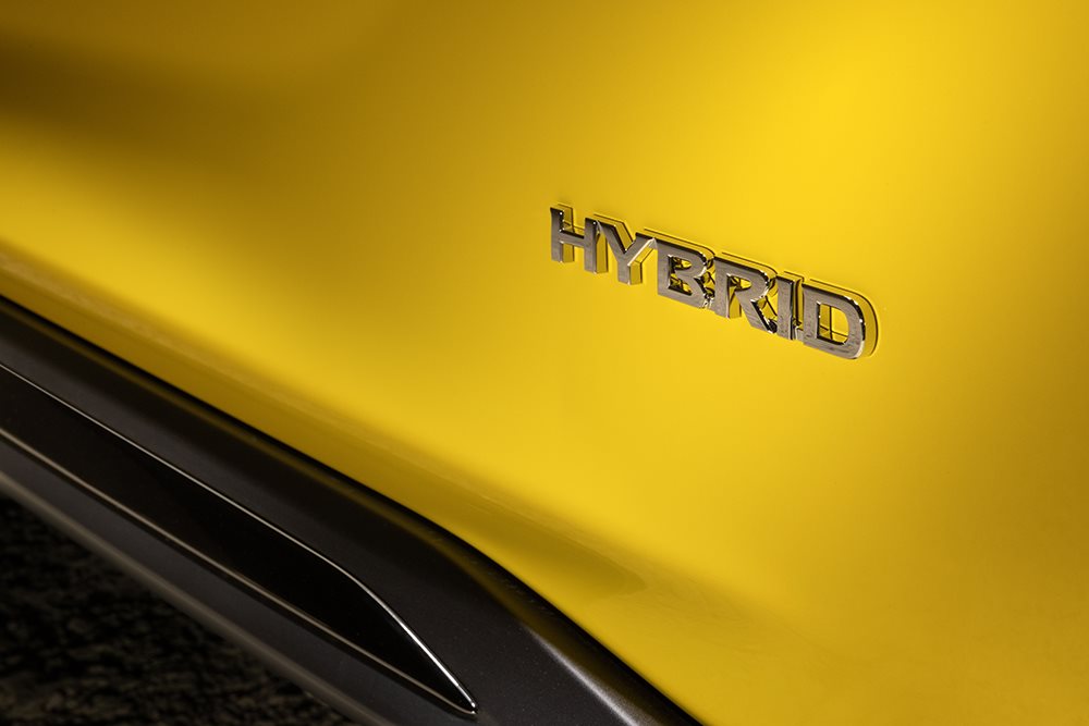 Close up of Hybrid writing on Yellow Nissan Juke