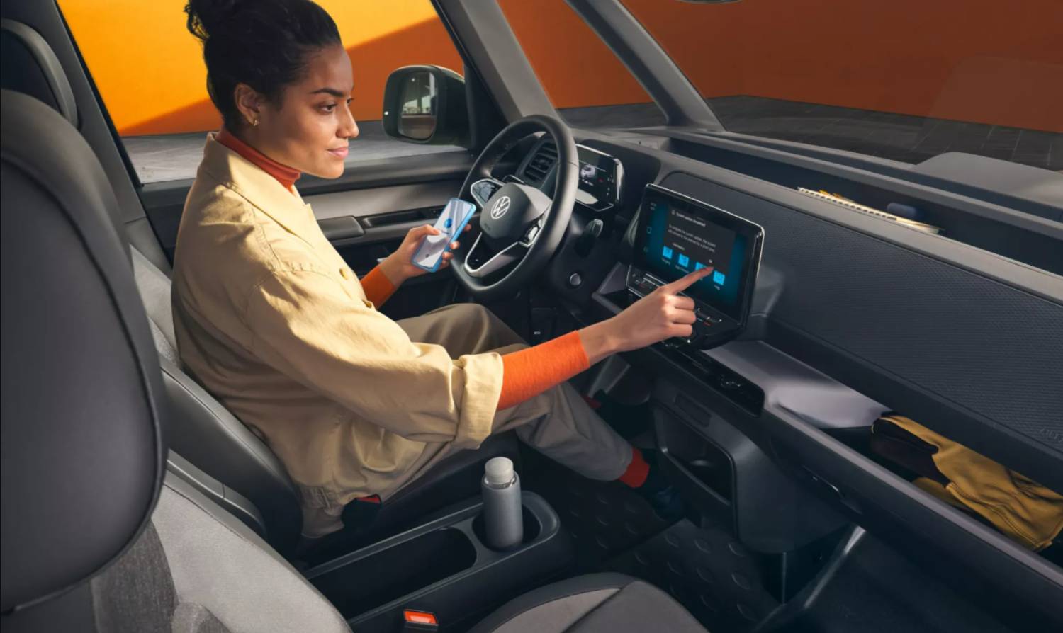 Driver sat in Volkswagen ID. Buzz Cargo using the infotainment system