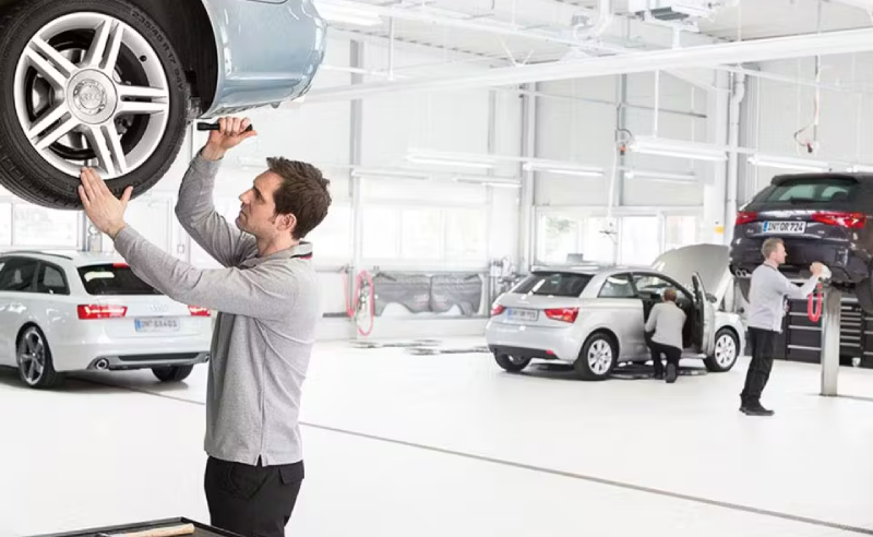 Audi Mechanic Inspecting Tyres
