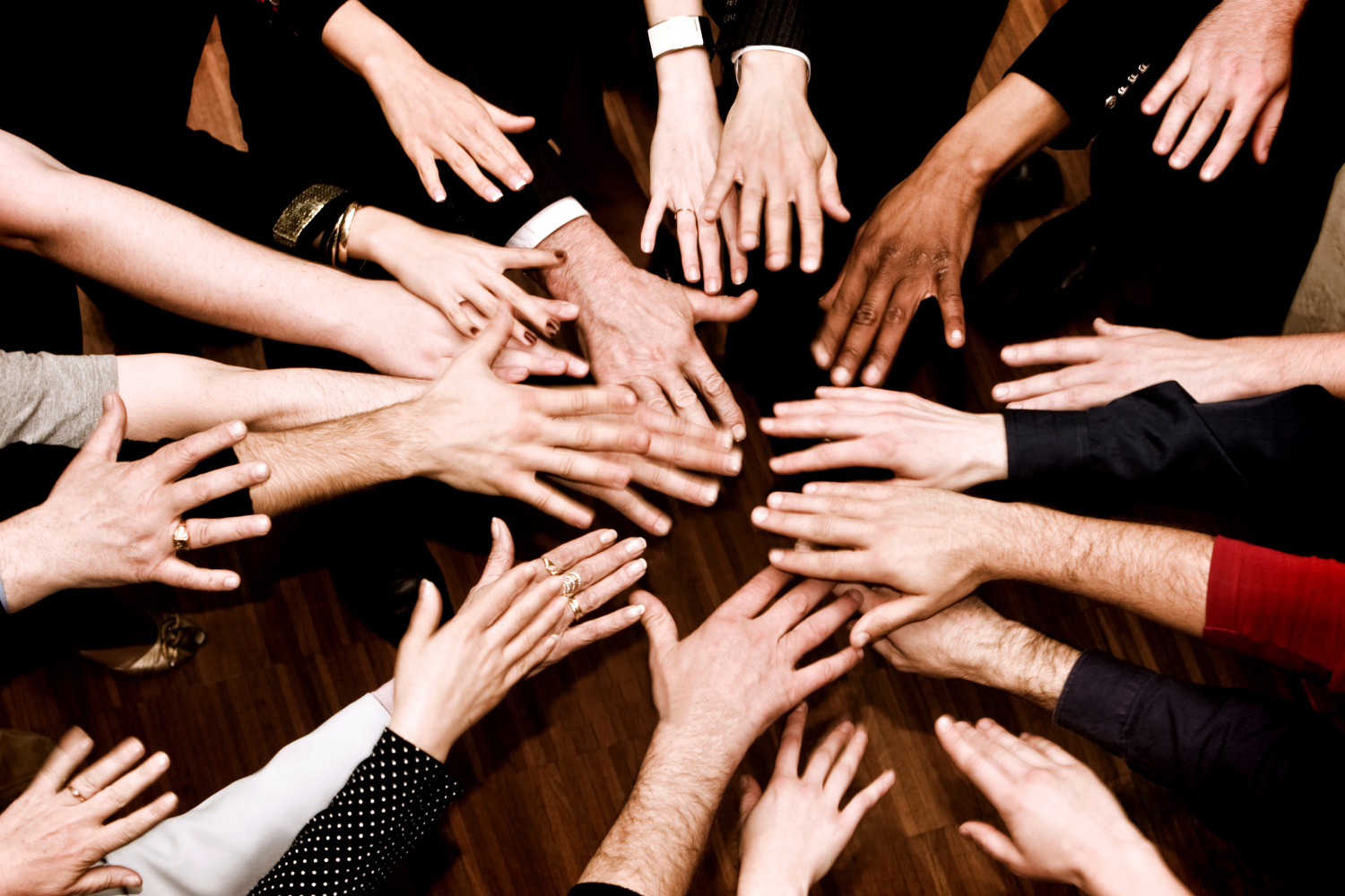 People uniting hands to symbolise collaboration and support.