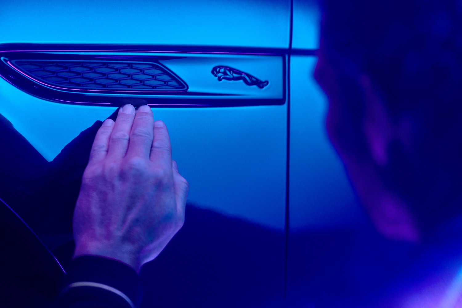 Close-up of Jaguar side vent and leaping cat badge detail.