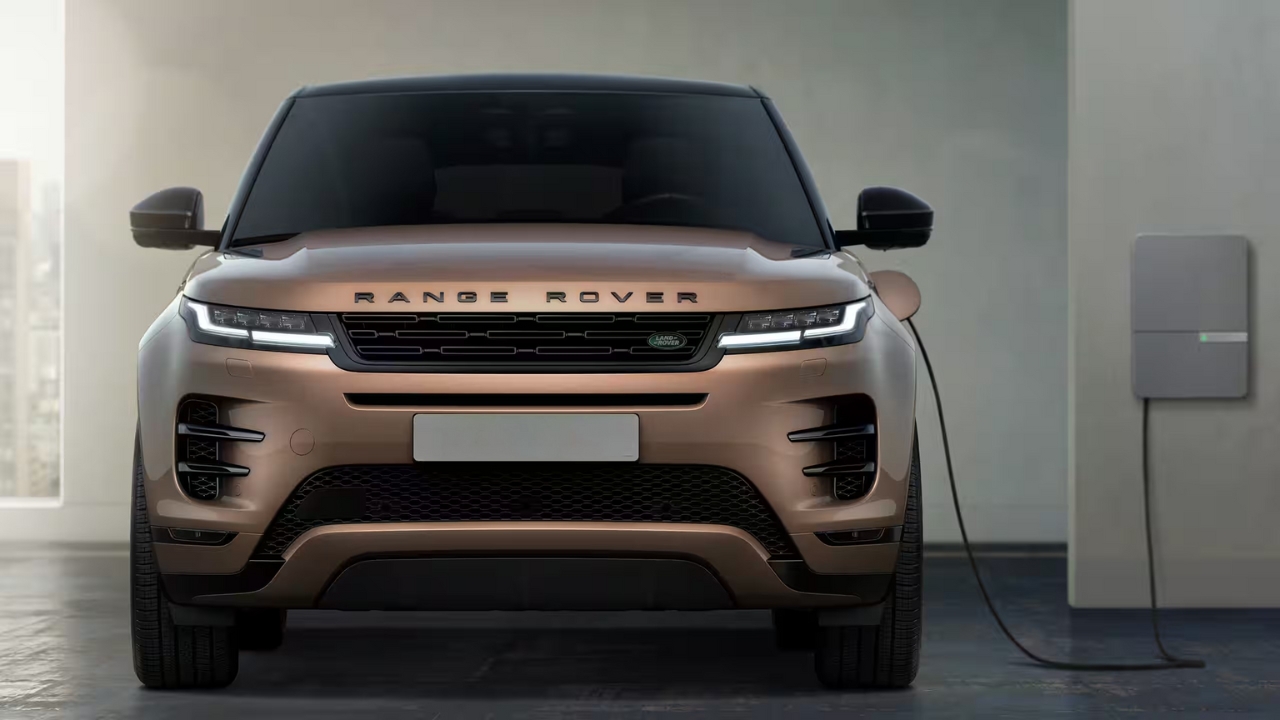Front view of a bronze Range Rover Evoque charging at a home wall charging station.