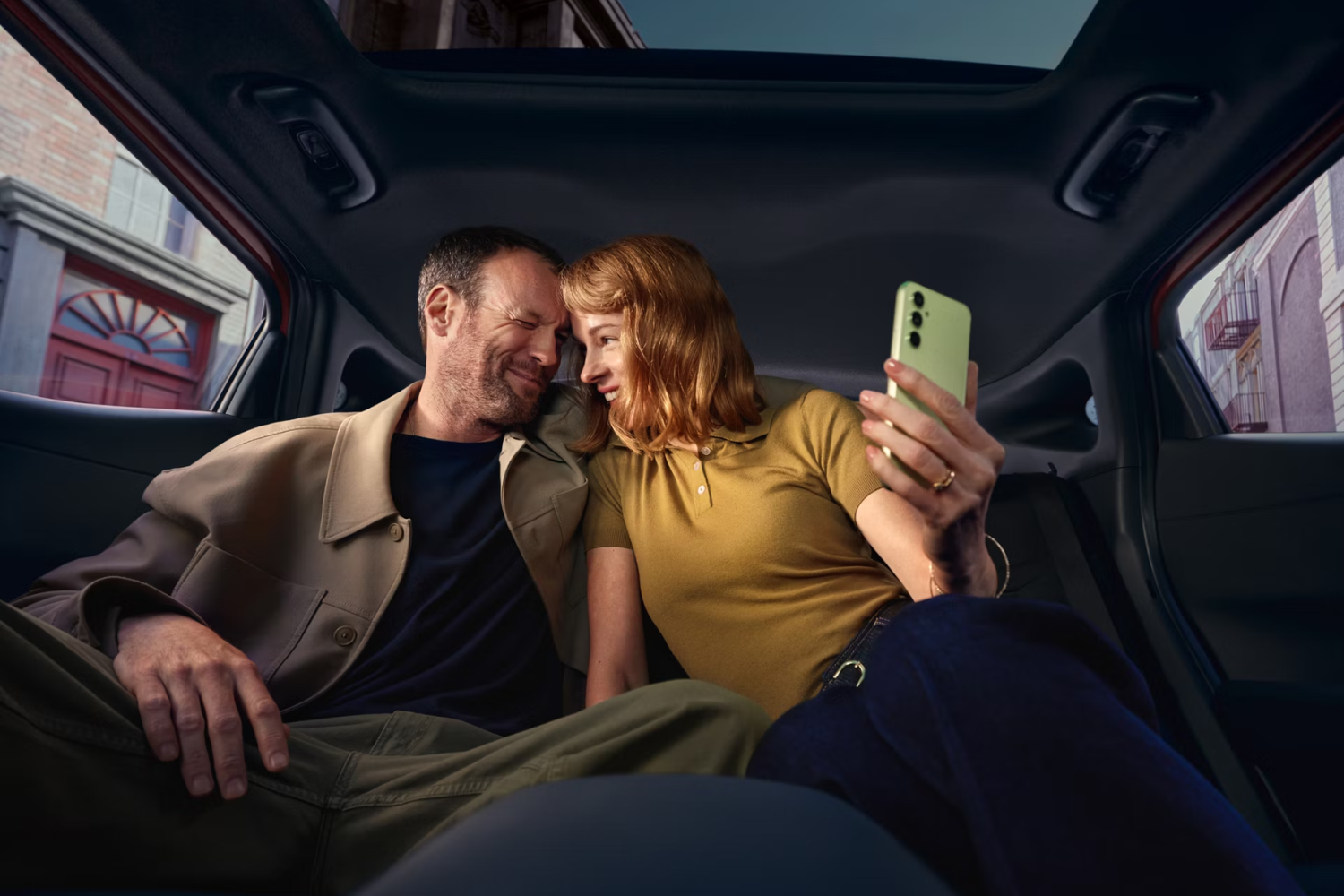 two people sat in back of new IONIQ 3 smiling