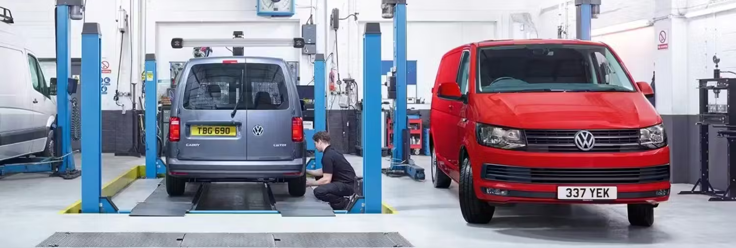 Two Vehicles In Volkswagen Workshop