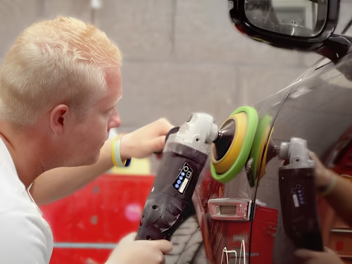 Professional paint correction using a rotary polisher to remove swirl marks and imperfections.
