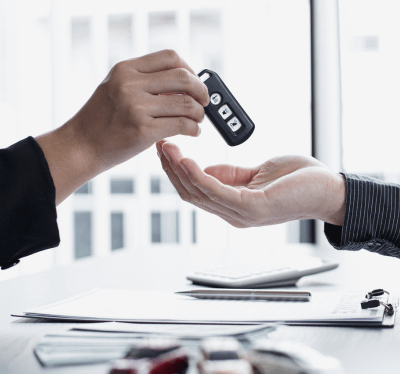 Person Handing Over Car Keys