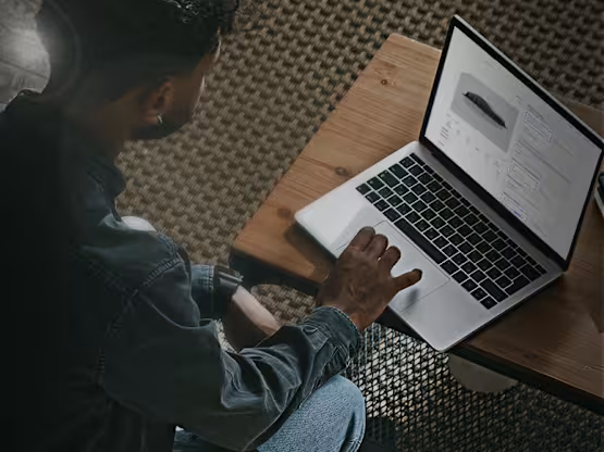 man using laptop to look at cars