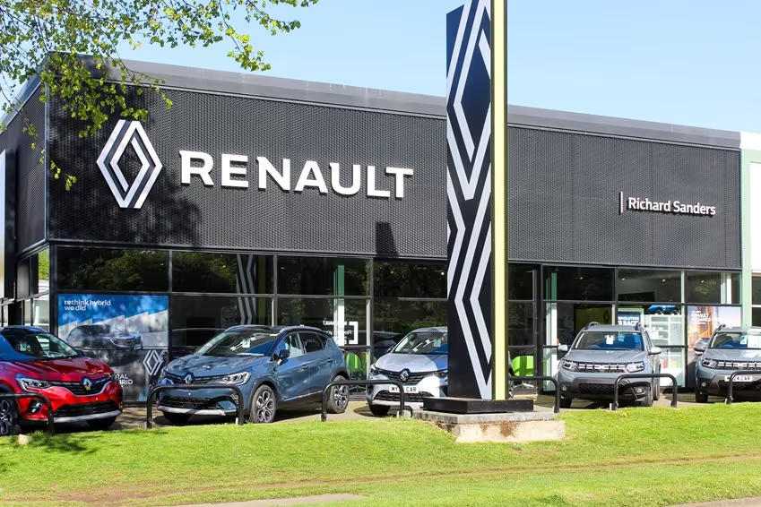 Exterior view of Renault dealership with multiple Renault models displayed outside and branded signage.