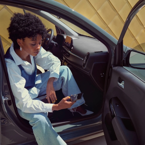 Exterior shot showing Kia Picanto cabin through an open side door.