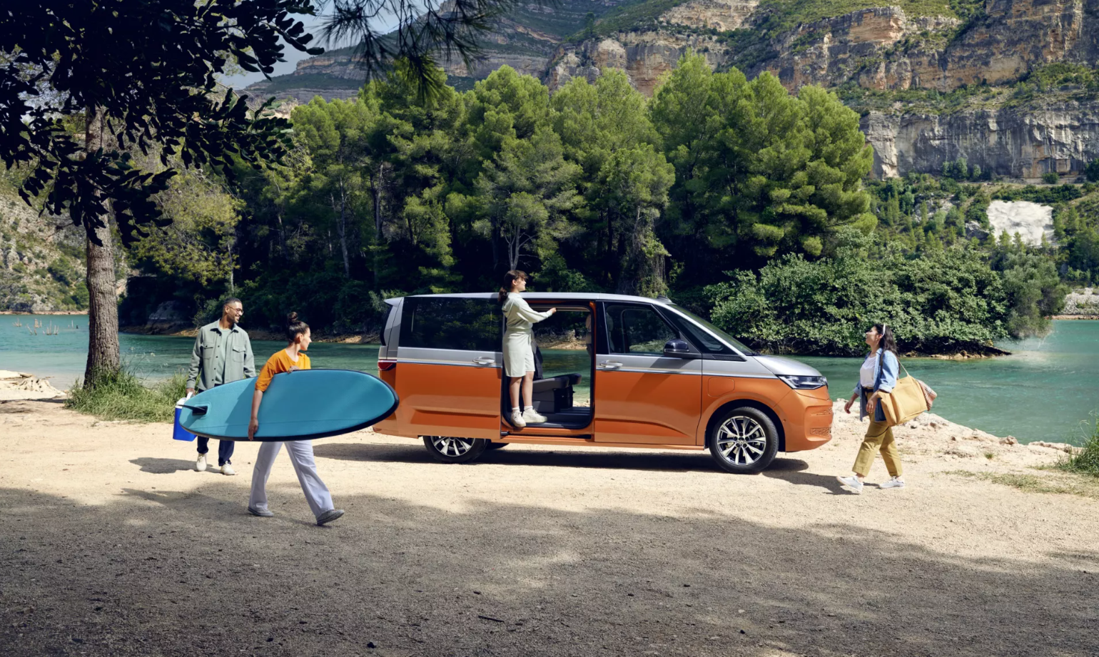 Orange and White New Volkswagen Multivan by lake