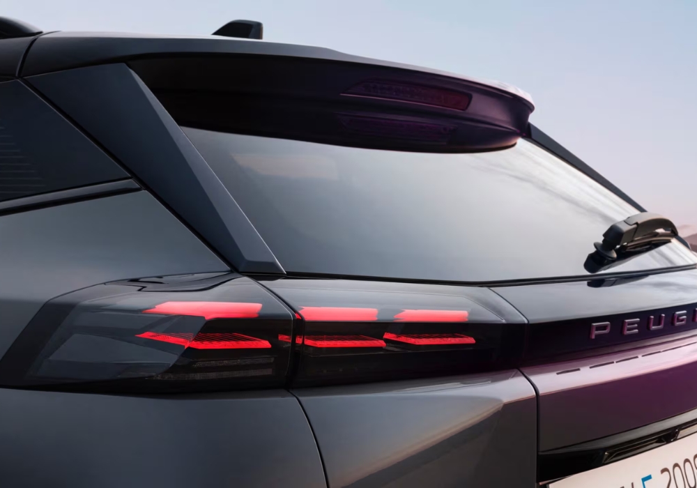 Peugeot 2008 rear light bar detail with illuminated LED signature and Peugeot branding.