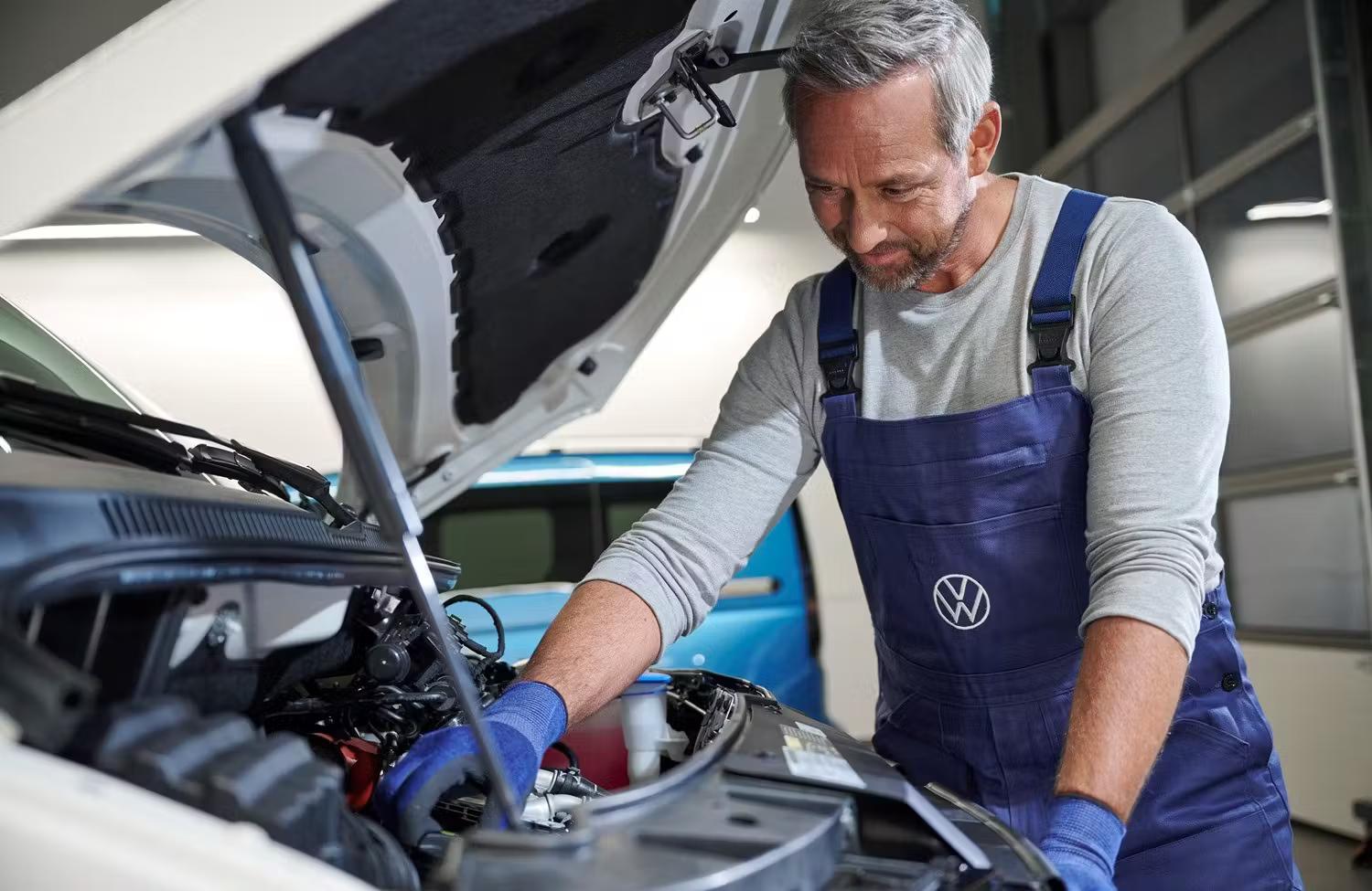Volkswagen Mechanic Inspecting VW engine