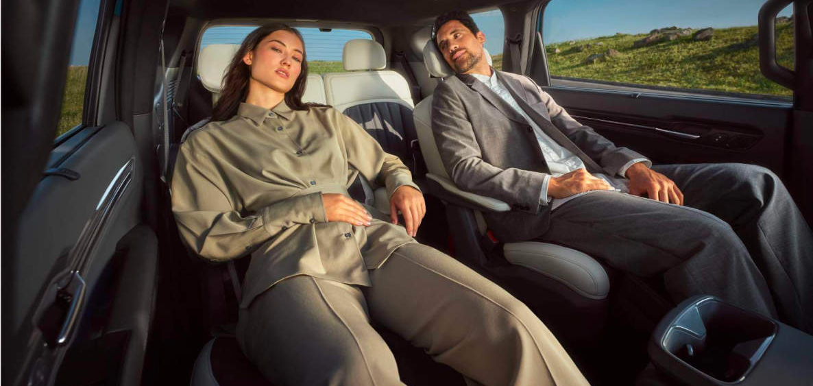 Two people inside of a Kia EV9