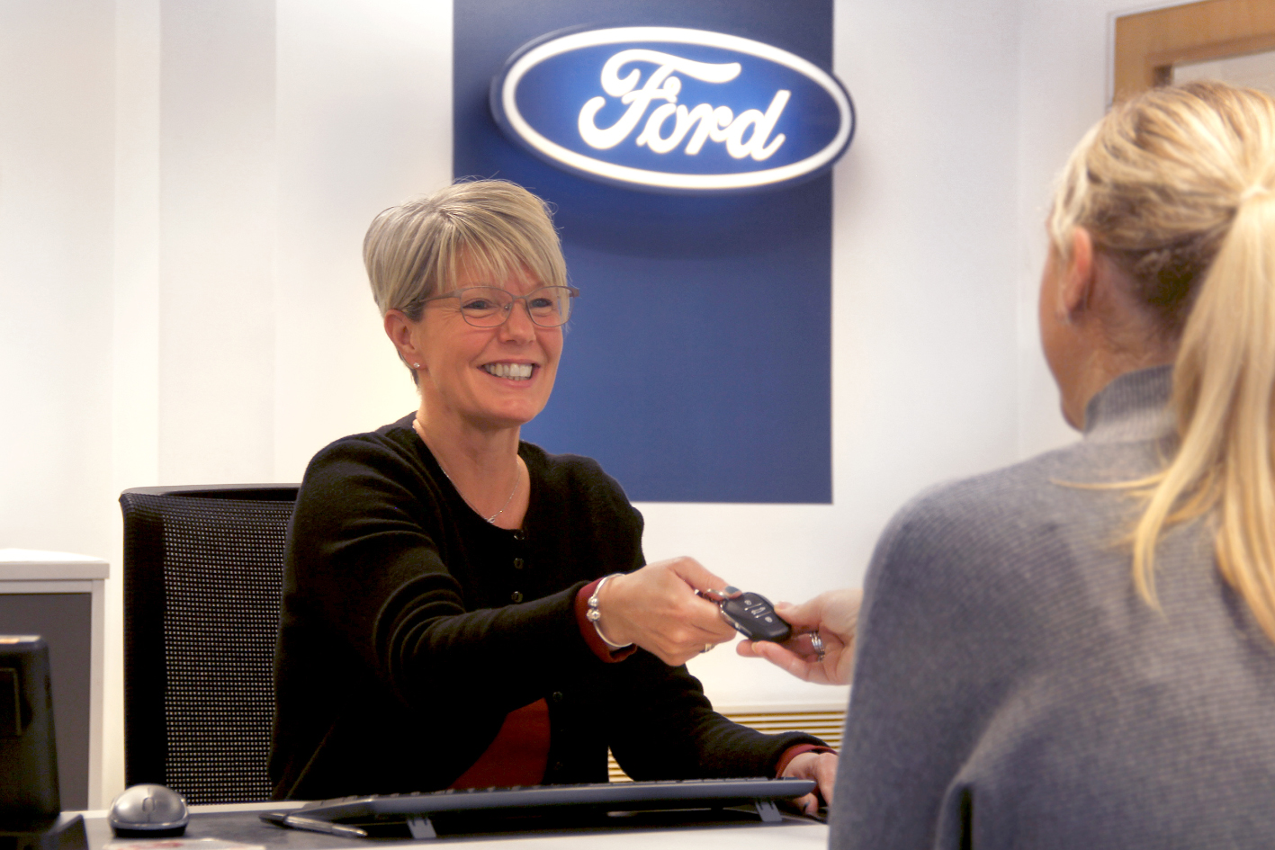 Underwoods Motoring adviser returning vehicle keys to a customer.