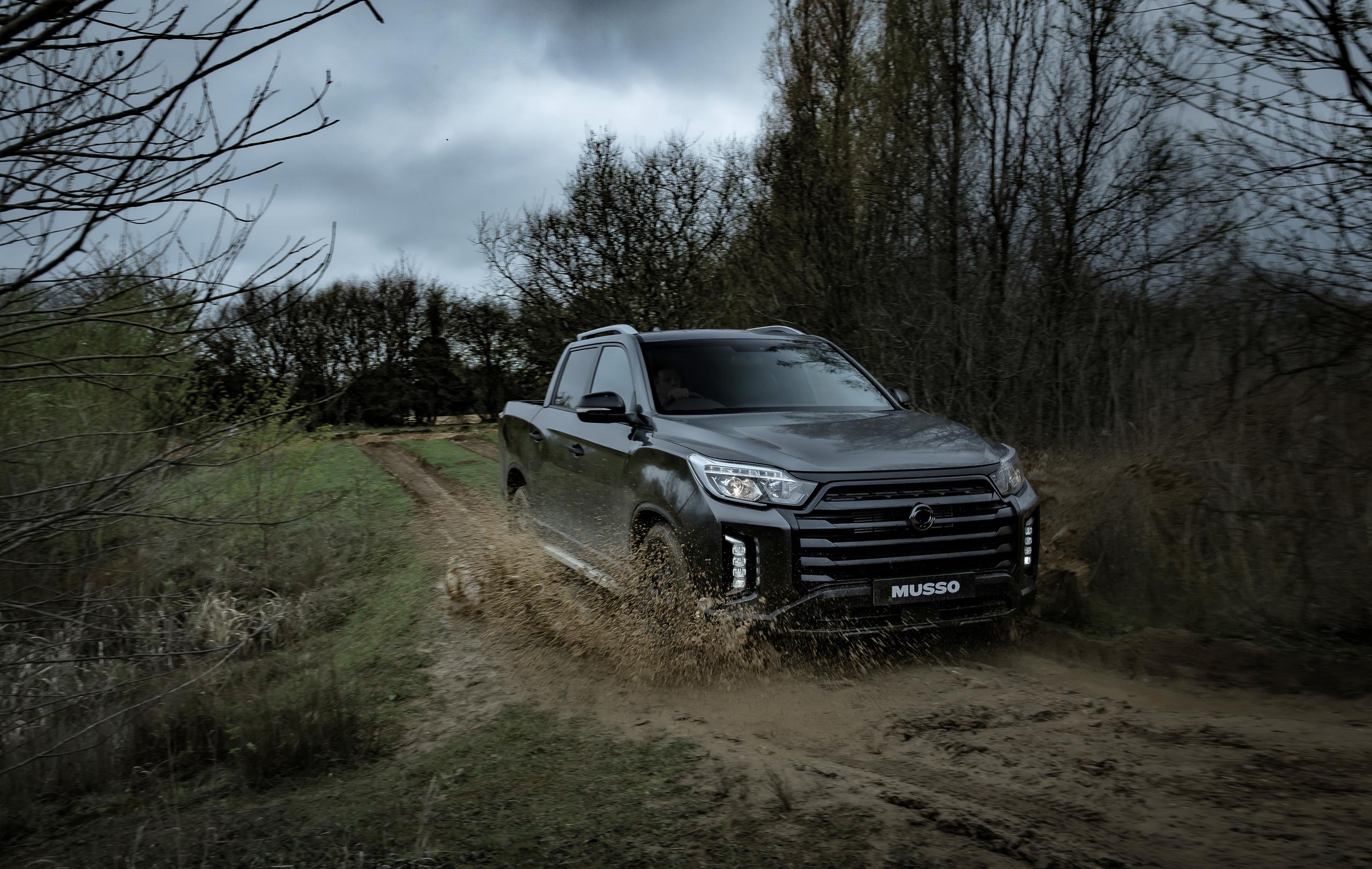 SsangYong Musso driving through mud 