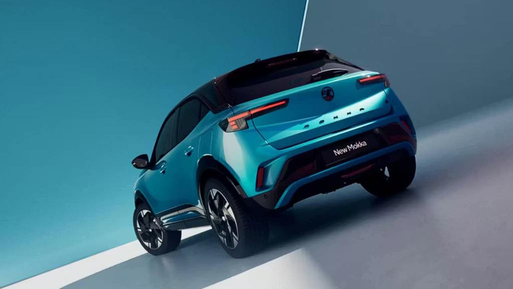Rear view of a teal Vauxhall Mokka in a modern studio setting.