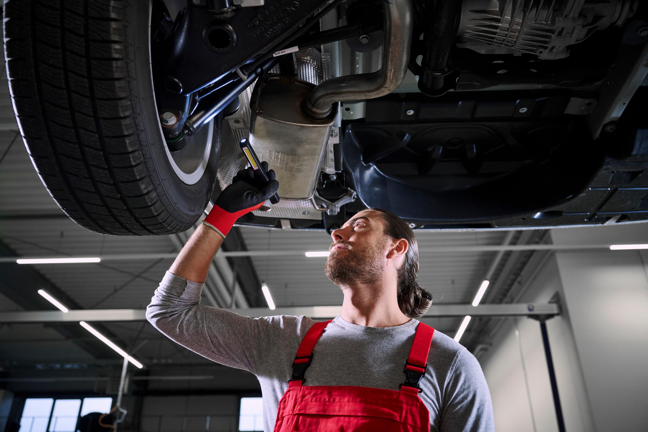 W Mechanic Inspecting VW Tyres
