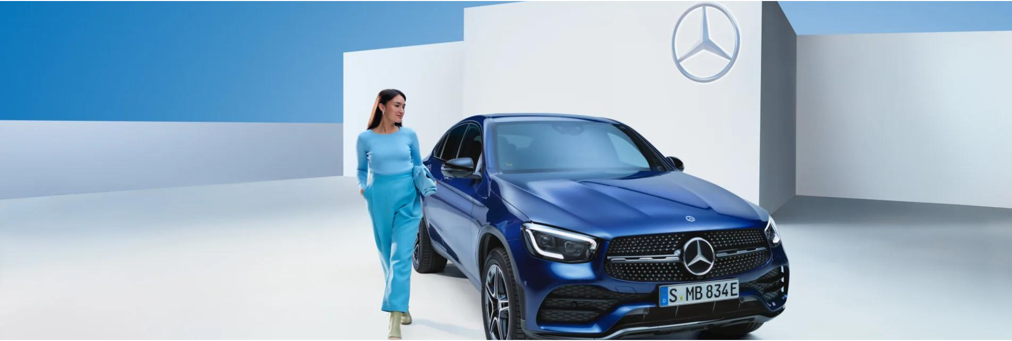 Person in front of Blue Mercedes-Benz Vehicle
