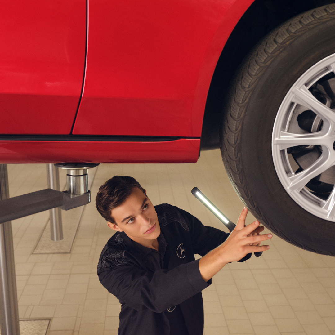 Mercedes-Benz Mechanic Inspecting Tyre