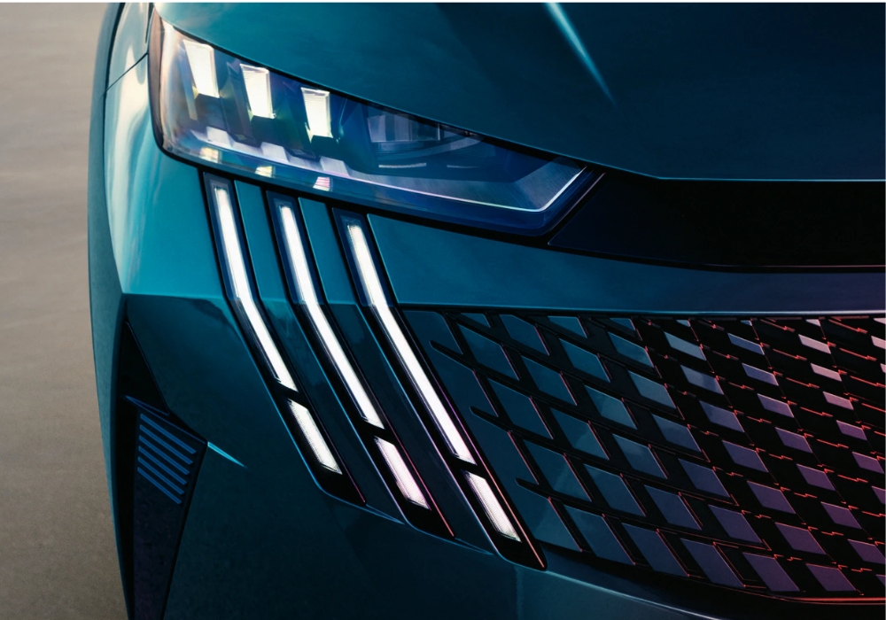Close-up of Peugeot E-3008 LED headlight and distinctive vertical daytime running lights.