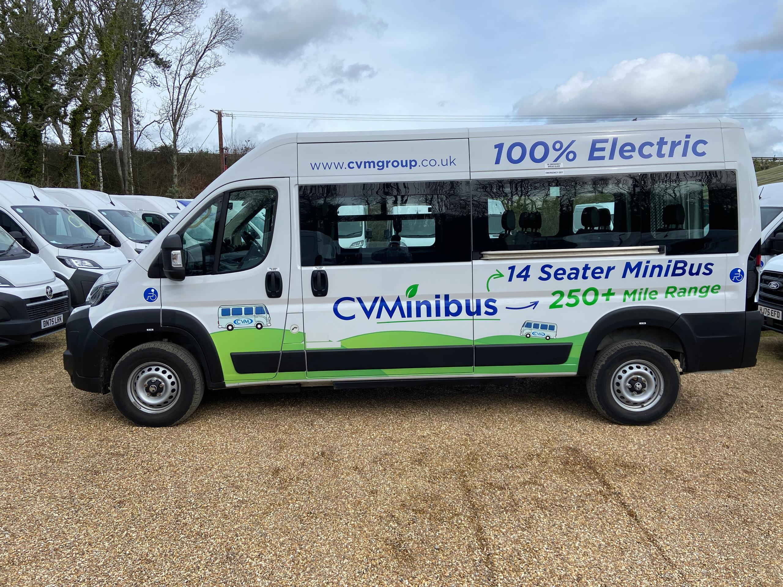 CVMinibus electric 14-seater minibus shown in full side profile with branding visible.