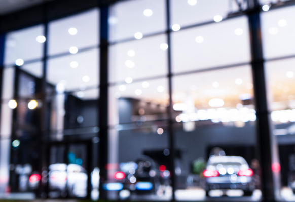 Out of focus image taken from outside of car dealership.