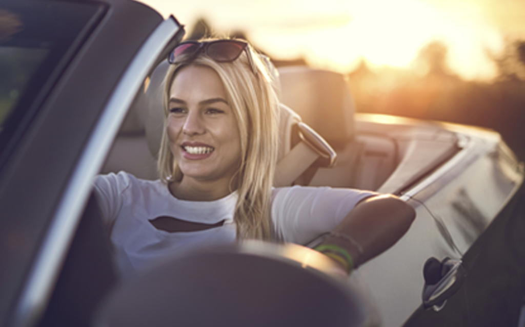 Woman driving convertible car