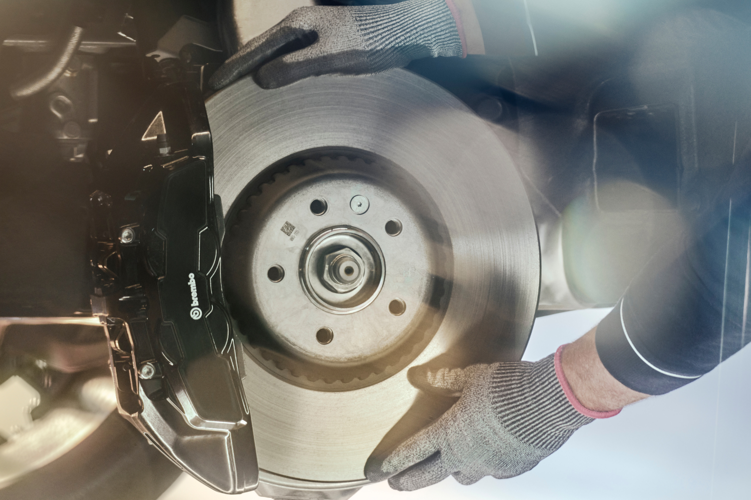 Range Rover brake disc and caliper during professional brake replacement.