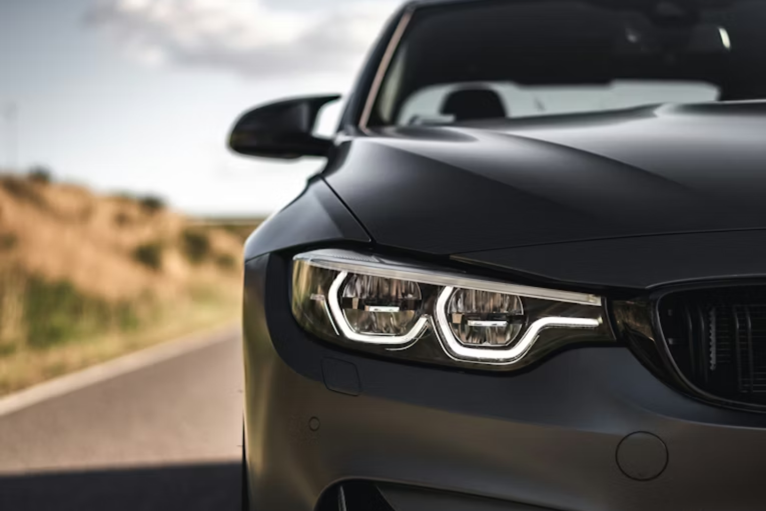 Close-up of BMW LED headlight and front grille.