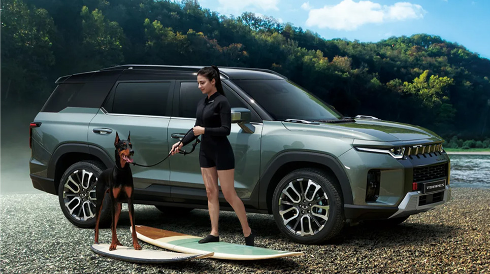 Woman and dog beside KGM Torres on surfboards