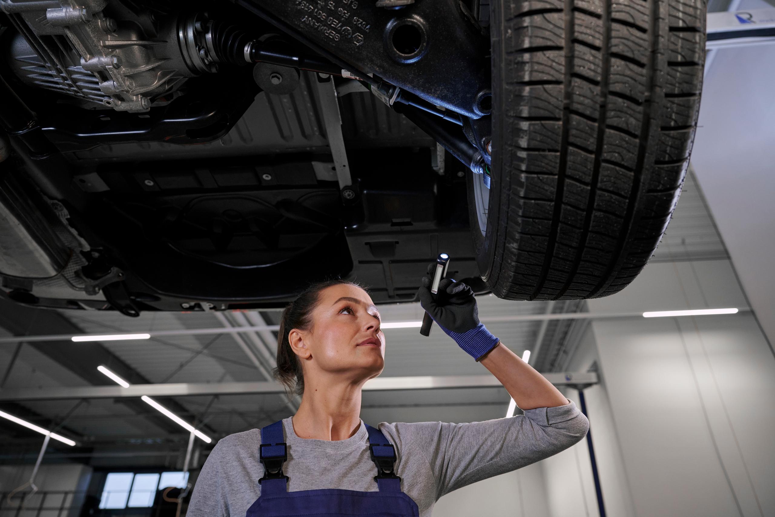 Volkswagen Mechanic Inspecting Tyre