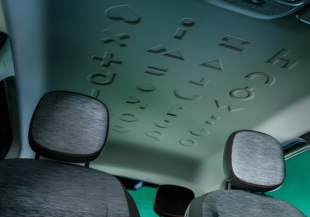 Embossed geometric shapes on the Renault Twingo headliner above the front seats.
